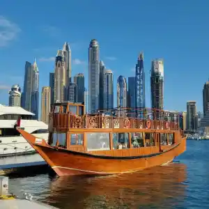 The view of Dubai Marina and traditional dhow boat in Dubai.